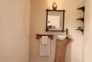 a bathroom with a sink and a mirror on the wall at Les Dunes de Dakhla in Dakhla