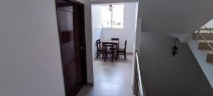 a hallway with a table and a dining room at Mantarraya in Puerto Baquerizo Moreno