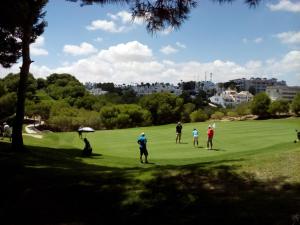 a group of people playing golf on a golf course at Casa Pelican in Orihuela Costa