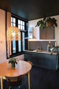 a kitchen with a wooden table and a sink and a table and a tablektop at Stadslogement Valentijn in Sneek