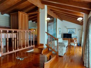 a living room with wooden floors and a staircase at Phi Hotel Dei Medaglioni in Correggio