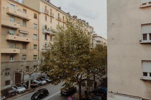 a view of a city street with a tree and buildings at Elettra's studio x4 totally renovated in Trieste