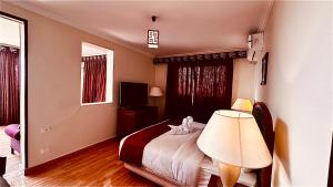 a hotel room with a bed and a lamp at PYRAMIDS TOWER Inn in Cairo