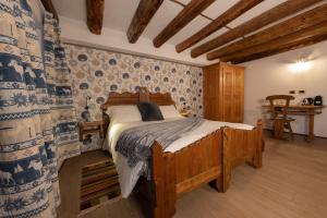 a bedroom with a wooden bed in a room at Chalet d'Aoste in Aosta