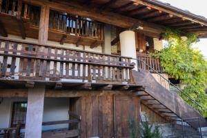 a wooden house with wooden stairs on it at Chalet d'Aoste in Aosta