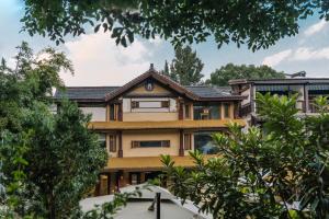 an image of a house with trees at Xianqingshan Homestay in Hangzhou