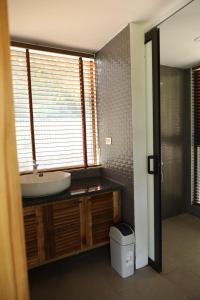 a bathroom with a sink and a toilet and a window at Sóc Sơn - Bird House in Sóc Sơn