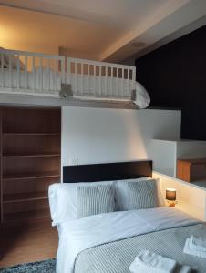 a bedroom with a bed and two bunk beds at Casa Xoubiña in Mos