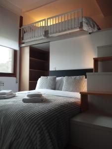 a bedroom with a bunk bed with two towels on it at Casa Xoubiña in Mos