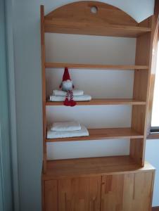 a shelf with a santa claus toy on it at Casa Xoubiña in Mos