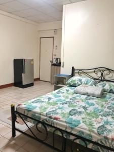 a bedroom with a bed and a refrigerator at Apartment near Train and Mall -Bangkok in Ban Khlong Samrong