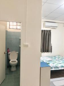 a bathroom with a toilet and a bed in a room at Apartment near Train and Mall -Bangkok in Ban Khlong Samrong