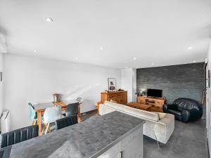 a living room with a couch and a table at Escale Affaires Dugny-Bourget in Dugny +20 photos