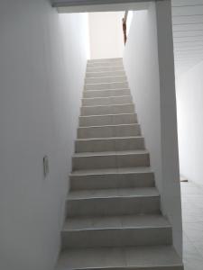 a staircase in a white room with a stair case at Hotel el huerto 