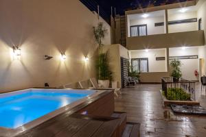 a swimming pool in a living room with a house at Casa Adefra Boutique Hotel Zona Colonial in Santo Domingo