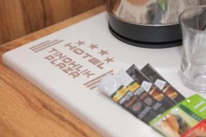 a sign on a table with a food processor at Hotel Tinchlik Plaza in Urganch
