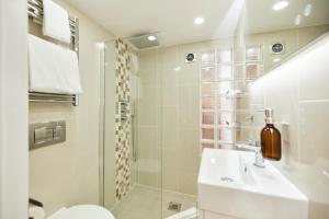 a bathroom with a sink and a shower at The Bermondsey Place - Cozy 2BDR Flat in London