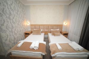 Ένα ή περισσότερα κρεβάτια σε δωμάτιο στο Hotel Tinchlik Plaza
