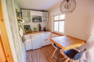 a small kitchen with a wooden table and a window at Ferienhaus Paula in Leipe