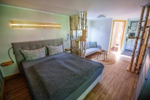 a bedroom with a bed and a living room at Ferienhaus Paula in Leipe