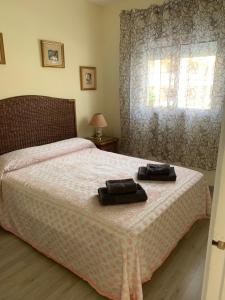a bedroom with a bed with two towels on it at Encantador apartamento en Dénia primera línea. in Denia