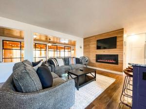 a living room with a couch and a fireplace at Peaceful Getaway / Heart of COS/mins to downtown in Colorado Springs