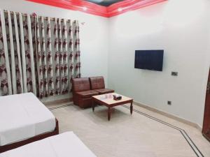 a living room with a couch and a coffee table at Gulshan Family Guest House Near Millennium Mall in Karachi