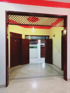 an open door to a room with a garage at Gulshan Family Guest House Near Millennium Mall in Karachi