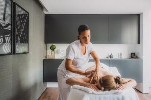 a woman getting a massage from a therapist at SLS Buenos Aires Puerto Madero in Buenos Aires