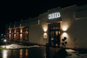 a hotel building at night with snow in front of it at Cruce de Gustos in Ivano-Frankivsʼk