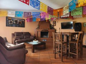 a living room with a couch and a table at Rancho San Miguel in Villa del Carbón