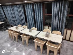 a conference room with a long table and chairs at Silver Dew Resorts and Restaurant in Dhanaulti