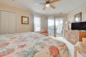a bedroom with a bed and a flat screen tv at North Myrtle Beach Condo Community Pool and Hot Tub in Myrtle Beach