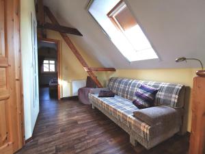 a living room with a couch and a skylight at Ferienhaus Layla in Leipe