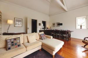 a living room with a couch and a dining room at Boavista Sunlit Duplex with Terrace in Porto