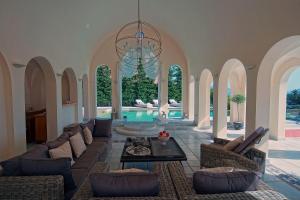 a living room with a couch and a chandelier at Villa Veneziano in Nydri