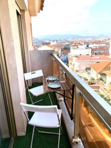 a balcony with two chairs and a table at Bel appartement Saint Raphaël in Saint-Raphaël