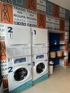 a laundry room with two washing machines and boxes at GRAY ONE - Apto novo, moderno, varanda, poucos passos da estação Luz in Sao Paulo