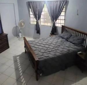 a bedroom with a large bed and a window at Caribbean Dreams in Mayaguez
