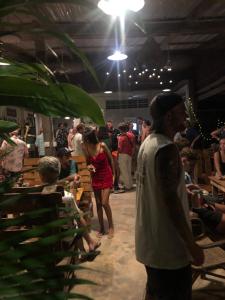 a group of people standing in a room with a crowd at Macondo in Koh Rong Sanloem