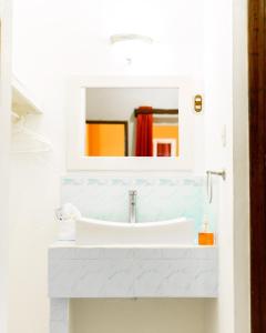 a bathroom with a sink and a mirror at Hotel Villa del Lago in Flores