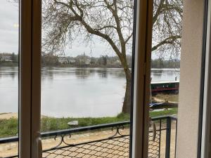 a view of a river from a window at Maison du pêcheur , située sur les bords de la Loire dans un lieu calme et paisible. in Rochefort-sur-Loire