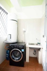 a washing machine in a bathroom with a sink at Urban Living 2Br Westlands, King & Queen size Beds in Nairobi