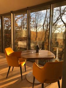 a table and chairs in a room with a window at Ciméo in Nandrin