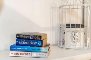 a stack of books and a bird cage on a shelf at Plaza Royal in the centre in Dubrovnik