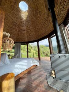 a bedroom with a bed and a vaulted ceiling at Tsia Bie Hotel in Choachí