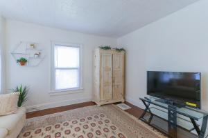 a living room with a flat screen tv and a couch at Cozy Bridgeport Apartment 2 Mi to Downtown! in Bridgeport