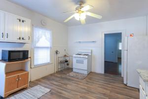 a kitchen with a ceiling fan and a white refrigerator at Cozy Bridgeport Apartment 2 Mi to Downtown! in Bridgeport