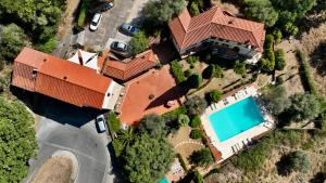 an overhead view of a house with a swimming pool at Madonna del Poggio B&B in Scarlino