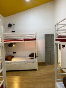 a room with three bunk beds and a wall at Seven Tales in Anjuna